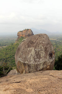 Rock formations on landscape against sky