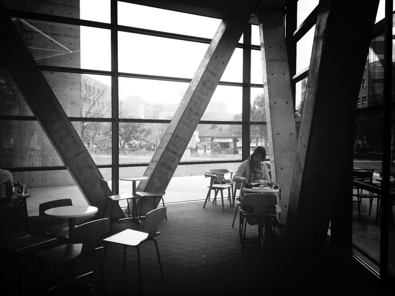 indoors, window, glass - material, architecture, built structure, transparent, chair, empty, table, absence, day, interior, glass, sunlight, modern, ceiling, airport, sky, railing, flooring