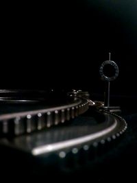 Close-up of piano keys against black background