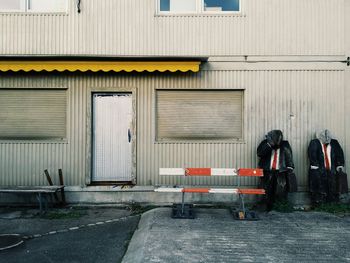 Businessman models against closed warehouse