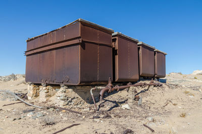 Abandoned storage tanks against clear sky