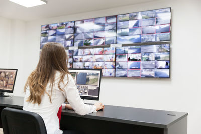 Businesswoman using computer at desk in office