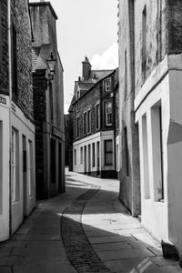 Empty alley amidst buildings in city