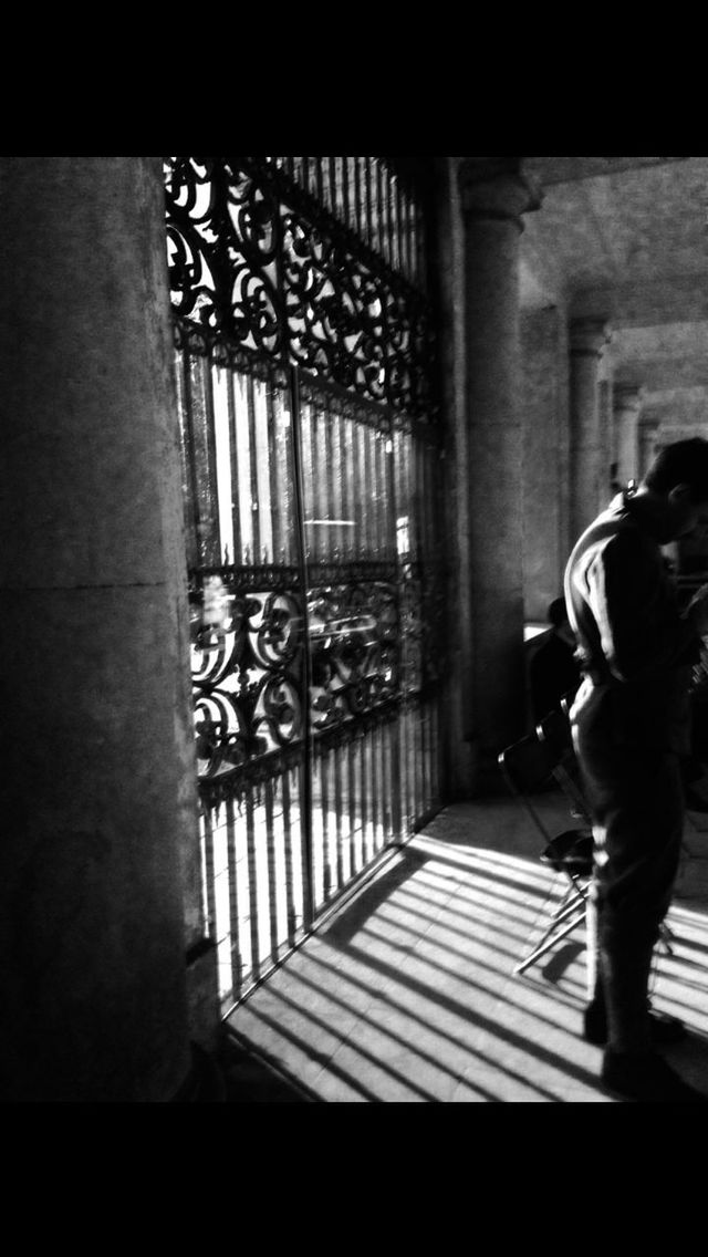 FULL LENGTH REAR VIEW OF MAN WALKING IN CORRIDOR OF BUILDING