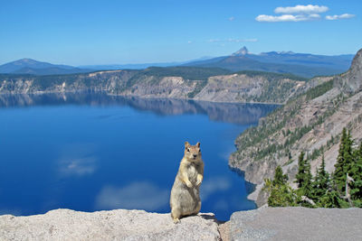 Panoramic view of lake by mountains against sky