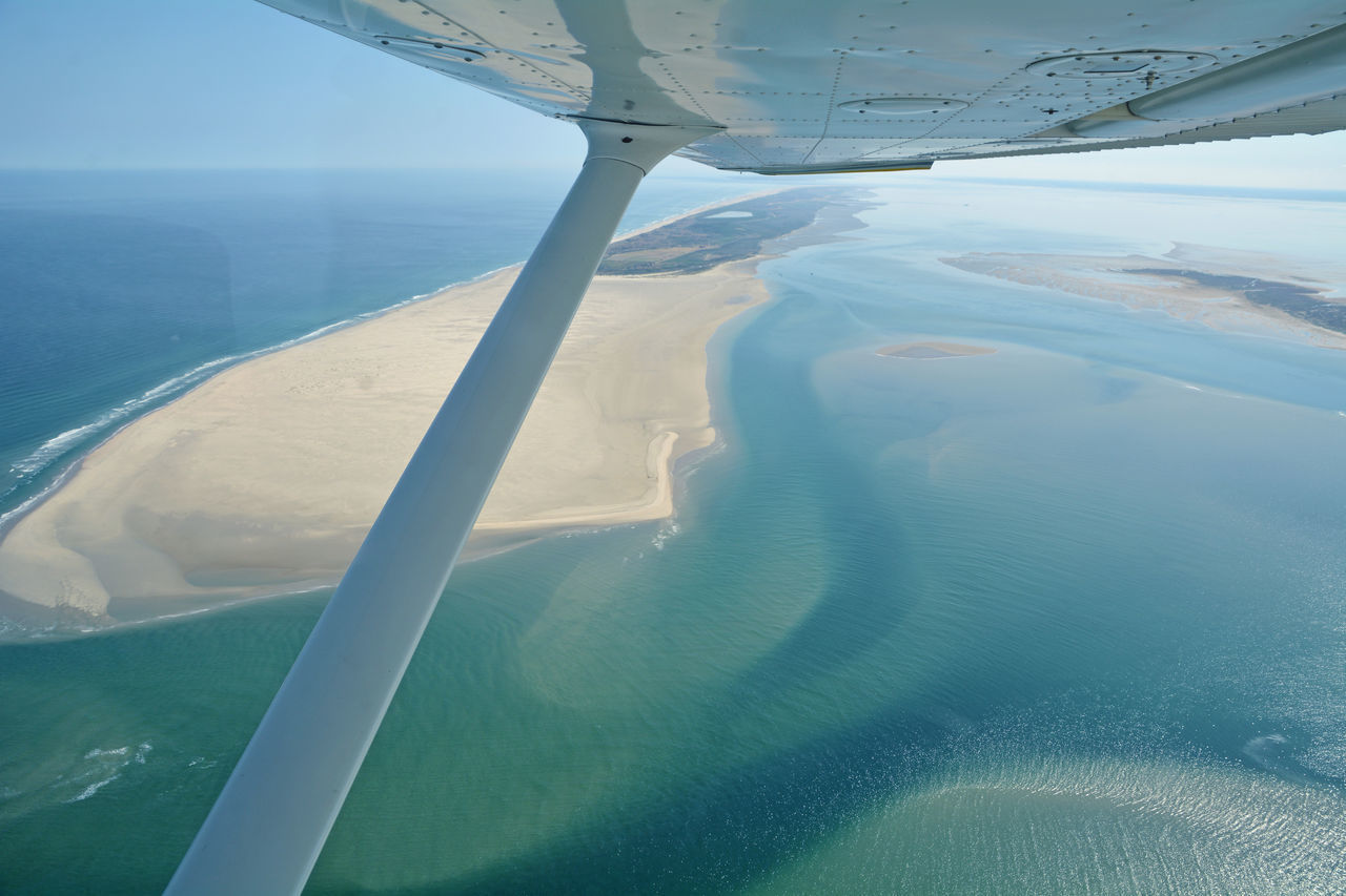 AERIAL VIEW OF SEA SEEN THROUGH AIRPLANE