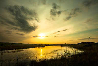 Scenic view of lake against romantic sky at sunset
