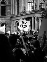 Group of people protesting in front of building