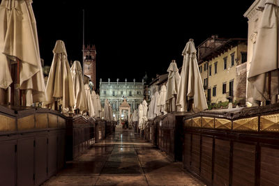 Illuminated buildings against clear sky at night