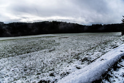 Scenic view of landscape against sky during winter