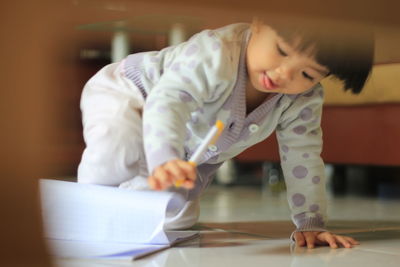 Girl playing with book at home