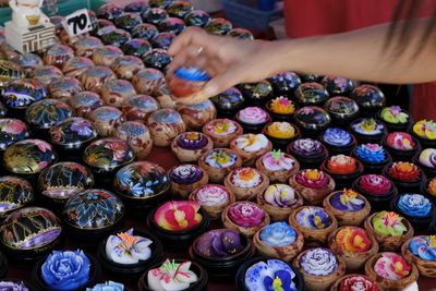 Midsection of person holding multi colored candies