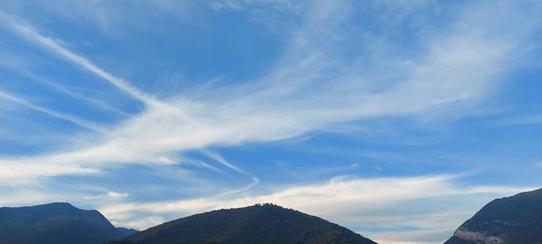 Low angle view of mountain against blue sky