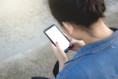 Midsection of man using mobile phone