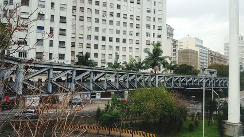 Bridge against buildings in city