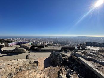 High angle view of buildings against blue sky on sunny day