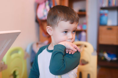 Cute young boy watching intently while bending his wrist