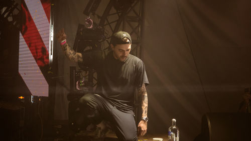 Young man sitting at music concert