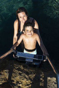 Portrait of a smiling young woman in water