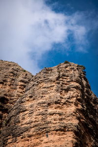 Low angle view of rock formation against sky