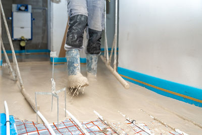 Low section of man working at construction site