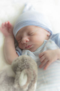 Close-up of baby sleeping on bed