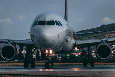 Airplane on runway against sky