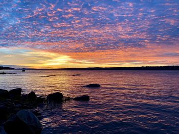 Scenic view of sea against romantic sky at sunset