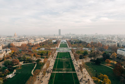 High angle view of city buildings against cloudy sky