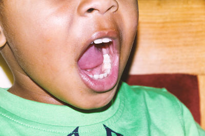 Midsection of boy with mouth open