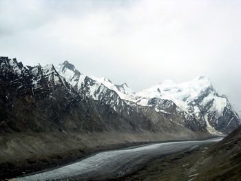 Scenic view of mountains against cloudy sky