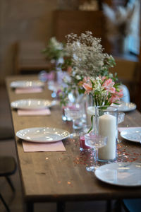 Flower vase on table in restaurant