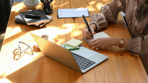 Midsection of woman working on table