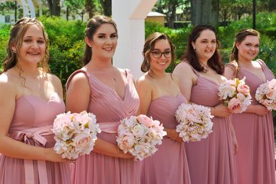 Portrait of bridesmaids holding bouquets