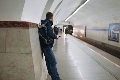 Full length of man standing on subway station