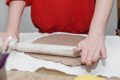 Women's hands knead clay, drawing elements of the product. production of ceramic products 