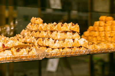 Mouthwatering, delicious display of golden, crunchy pastries in a bakery, desserts, pastry