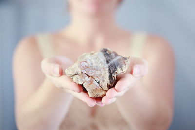 Close-up of woman holding leaf