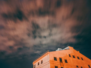 Low angle view of house against sky during sunset