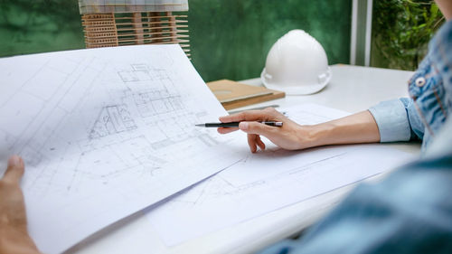 Midsection of woman working on table