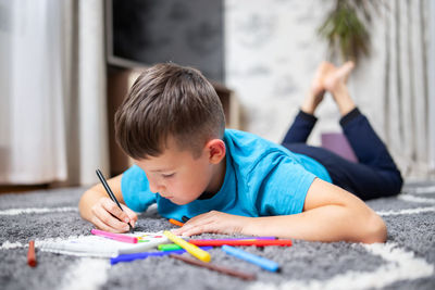 Boy drawing on book