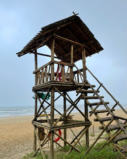 Low angle view of pier on beach against sky