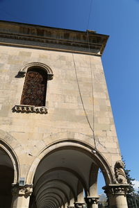 Low angle view of historical building against clear blue sky