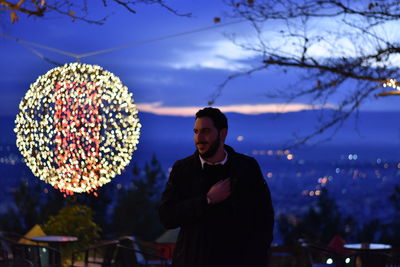 Man standing against sky at night