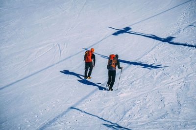 High angle view of people skiing on snowcapped field