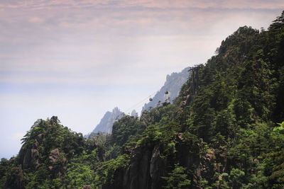 Scenic view of mountains against cloudy sky