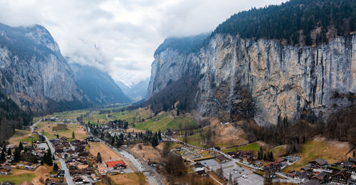 High angle view of townscape and mountains against sky