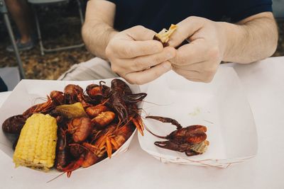 High angle view of person holding food on table