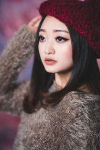 Portrait of beautiful woman in hat during winter