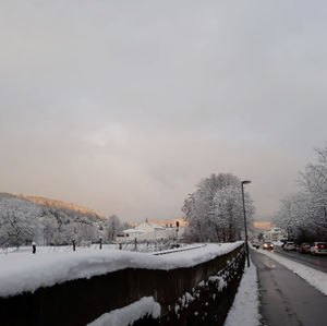 Snow covered canal against sky during winter